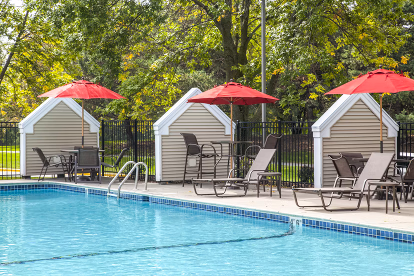 Outdoor pool area with sun loungers at Avana Southview Apartments offering resort-style relaxation