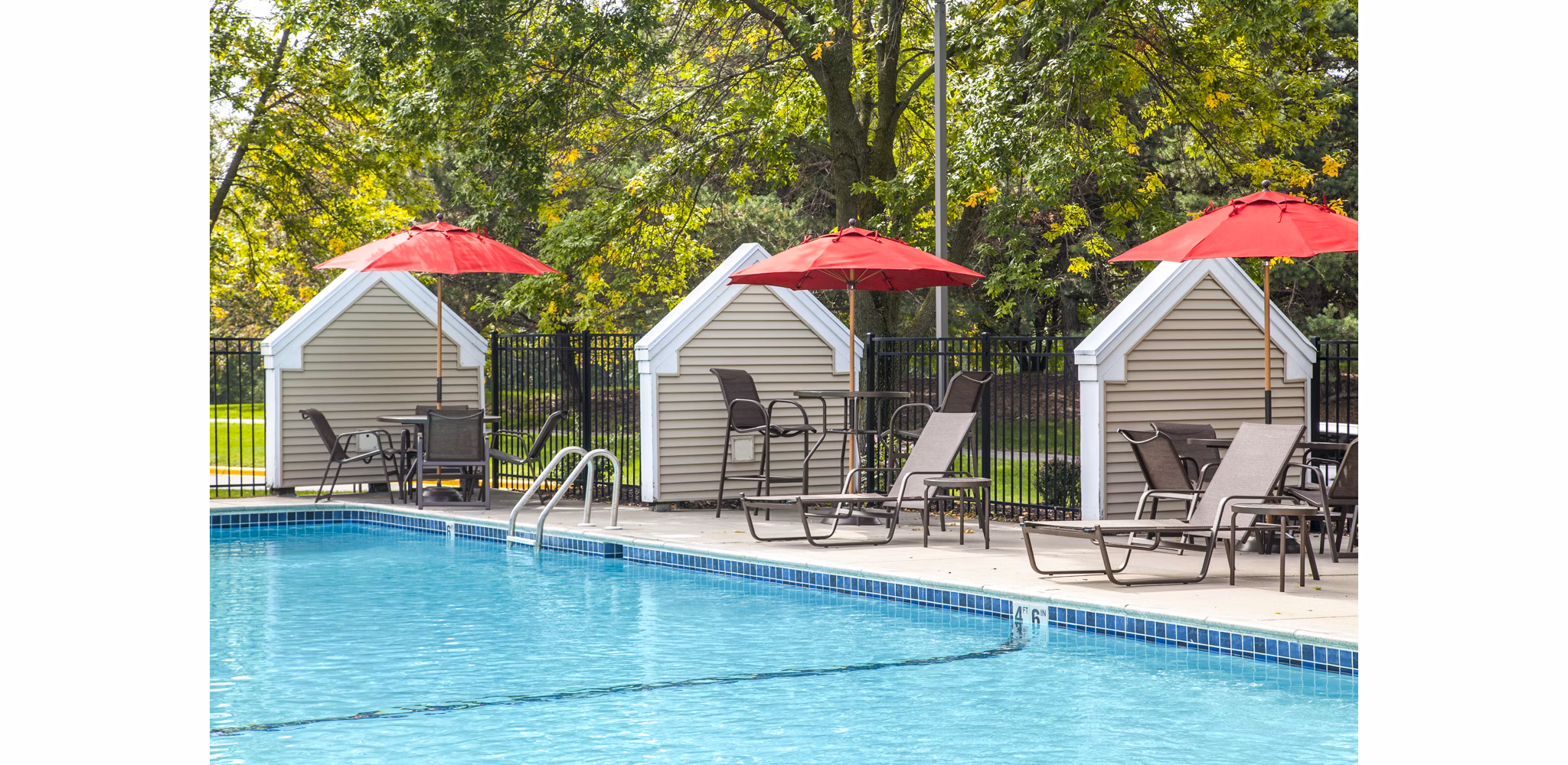 Outdoor pool area with sun loungers at Avana Southview Apartments offering resort-style relaxation