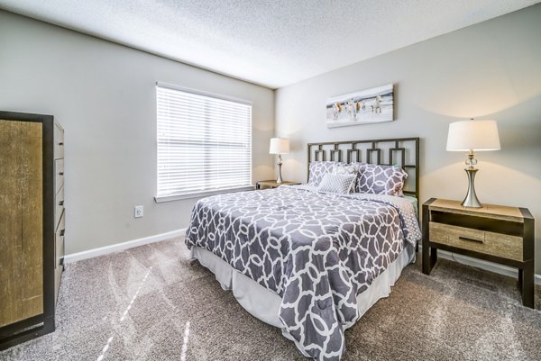 Spacious bedroom with stylish decor at Autumn Woods Apartments, luxury living by Greystar