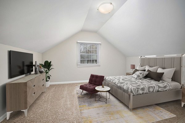 Spacious bedroom with large windows at Autumn Woods Apartments, offering natural light and serene design for luxury living