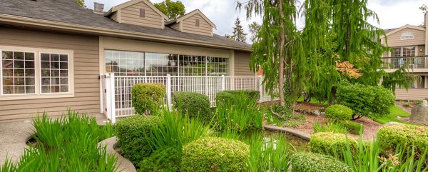 Riverstone Apartments: Elegant view of luxury apartments with lush landscaping in the vibrant community of Riverstone