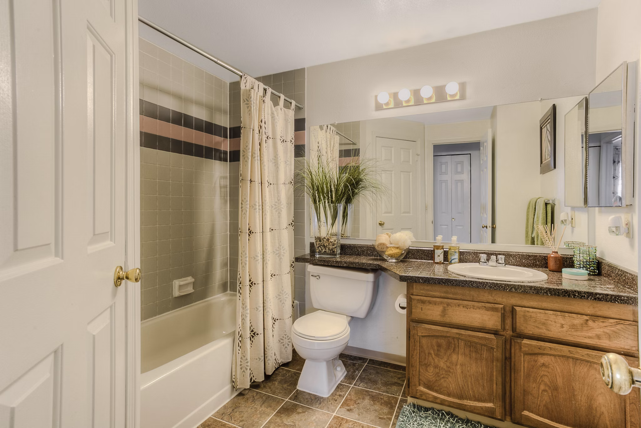 Riverstone Apartments: Bright kitchen with stainless steel appliances and granite countertops, ideal for modern cooking and dining experiences