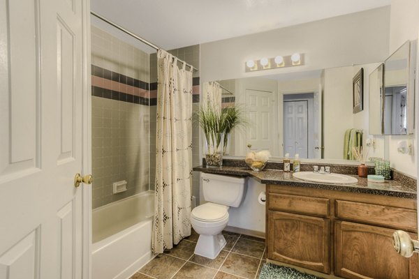 Riverstone Apartments: Bright kitchen with stainless steel appliances and granite countertops, ideal for modern cooking and dining experiences