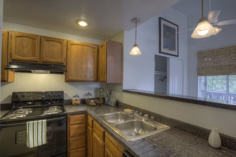 Modern kitchen with stainless steel appliances in Riverstone Apartments at Greystar luxury living