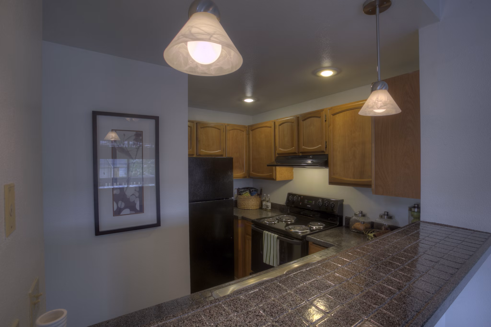 Modern kitchen with sleek countertops and stainless steel appliances at Riverstone Apartments