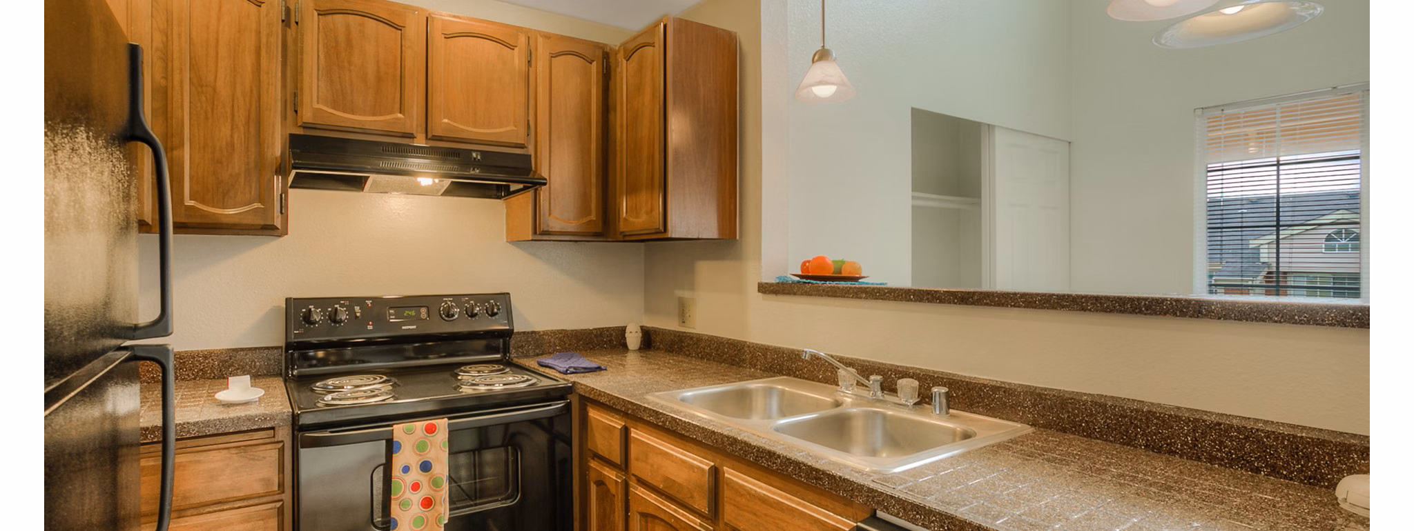 Modern kitchen featuring stainless steel appliances and granite countertops in Riverstone Apartments luxury living