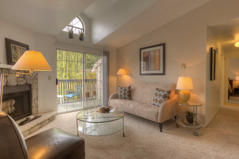 Stylish living room with modern decor and expansive windows in Riverstone Apartments