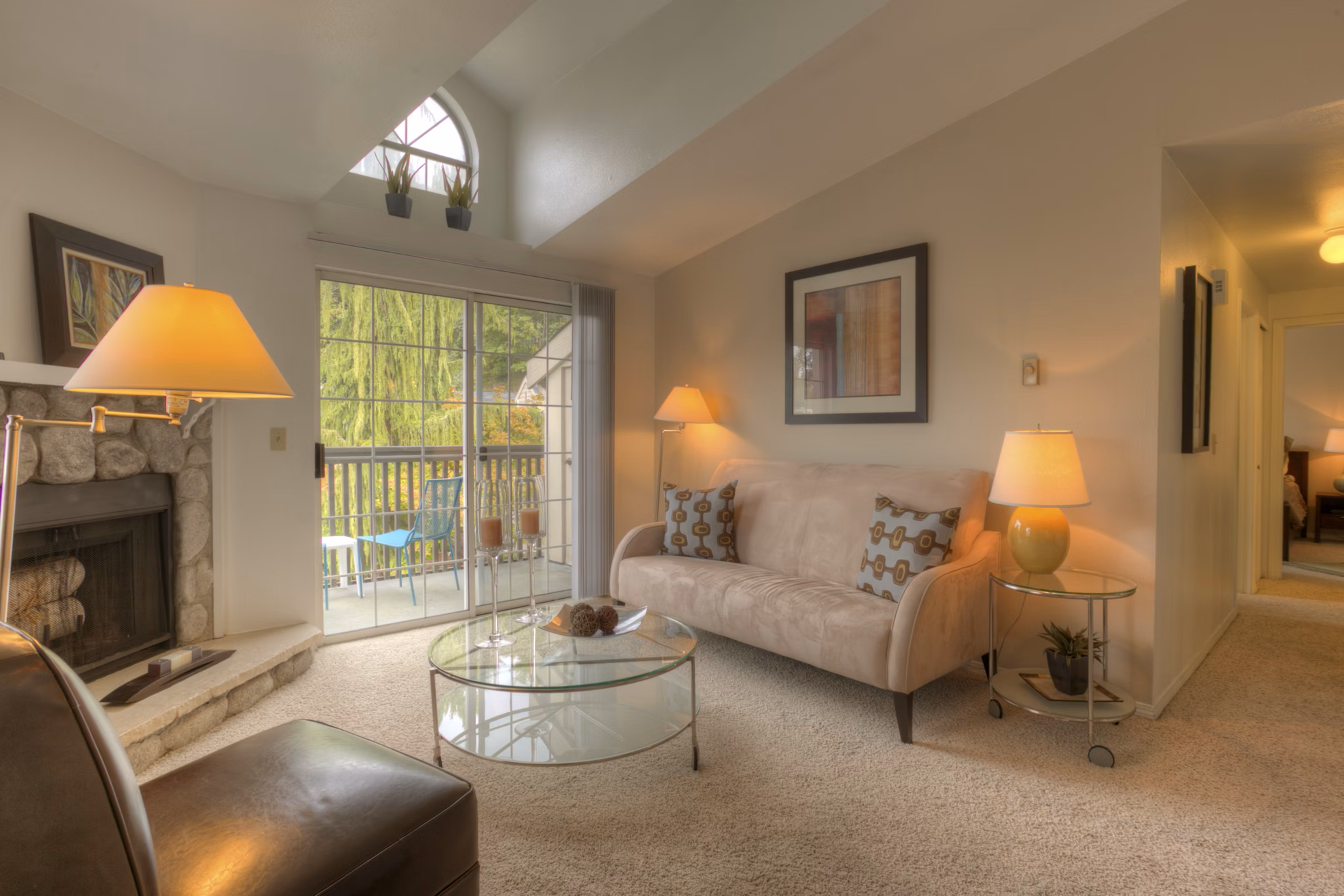 Stylish living room with modern decor and expansive windows in Riverstone Apartments