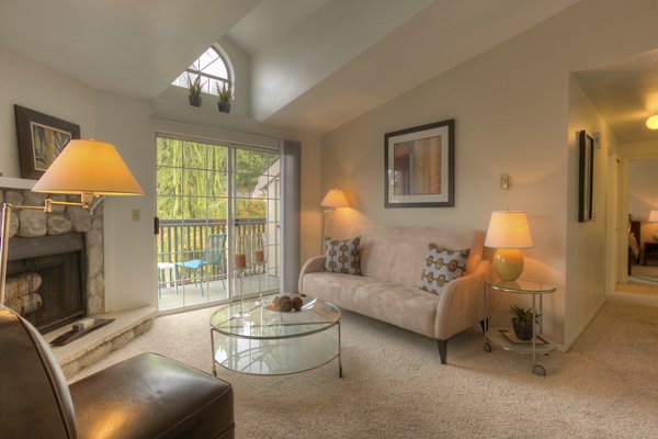Stylish living room with modern decor and expansive windows in Riverstone Apartments