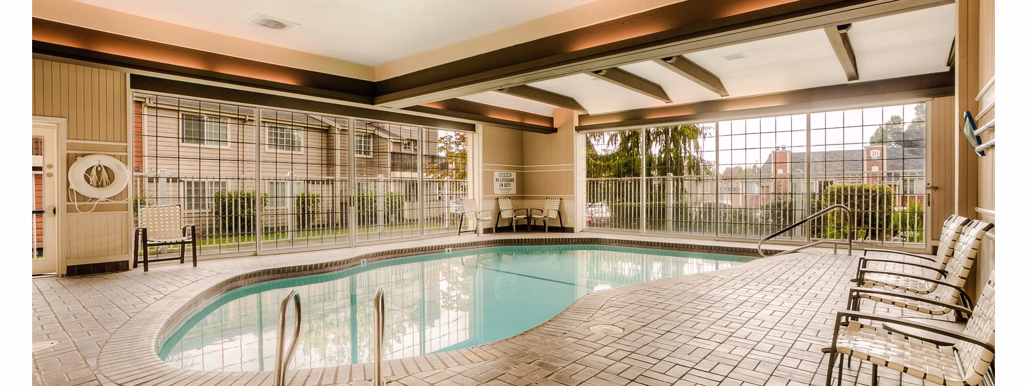 Relaxing outdoor pool at Riverstone Apartments offering tranquil swim experience
