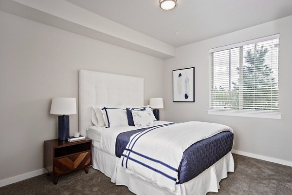 Bedroom featuring modern design and plush bedding at Trio Pointe