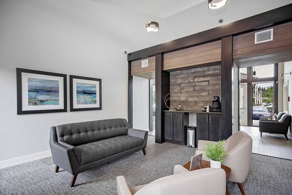 Modern clubhouse with stylish seating and game area at Trio Pointe apartments