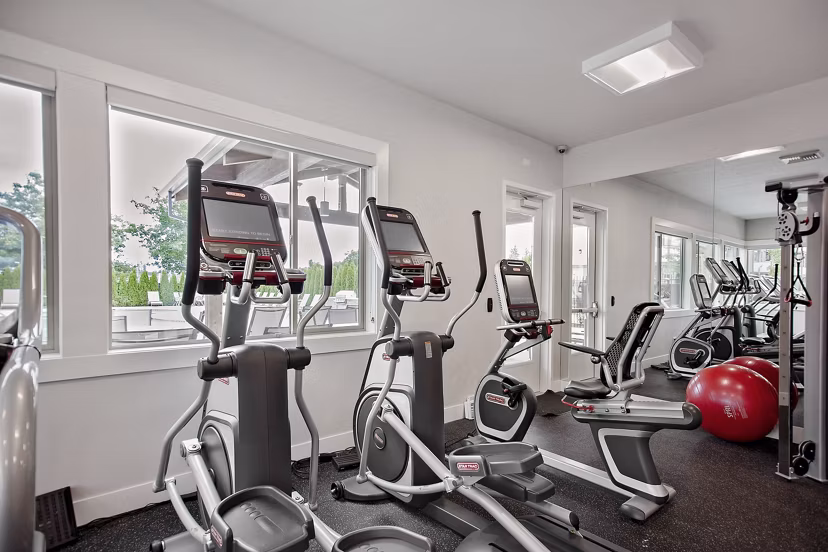 State-of-the-art fitness center at Trio Pointe luxury apartments, equipped with modern exercise machines and spacious workout areas