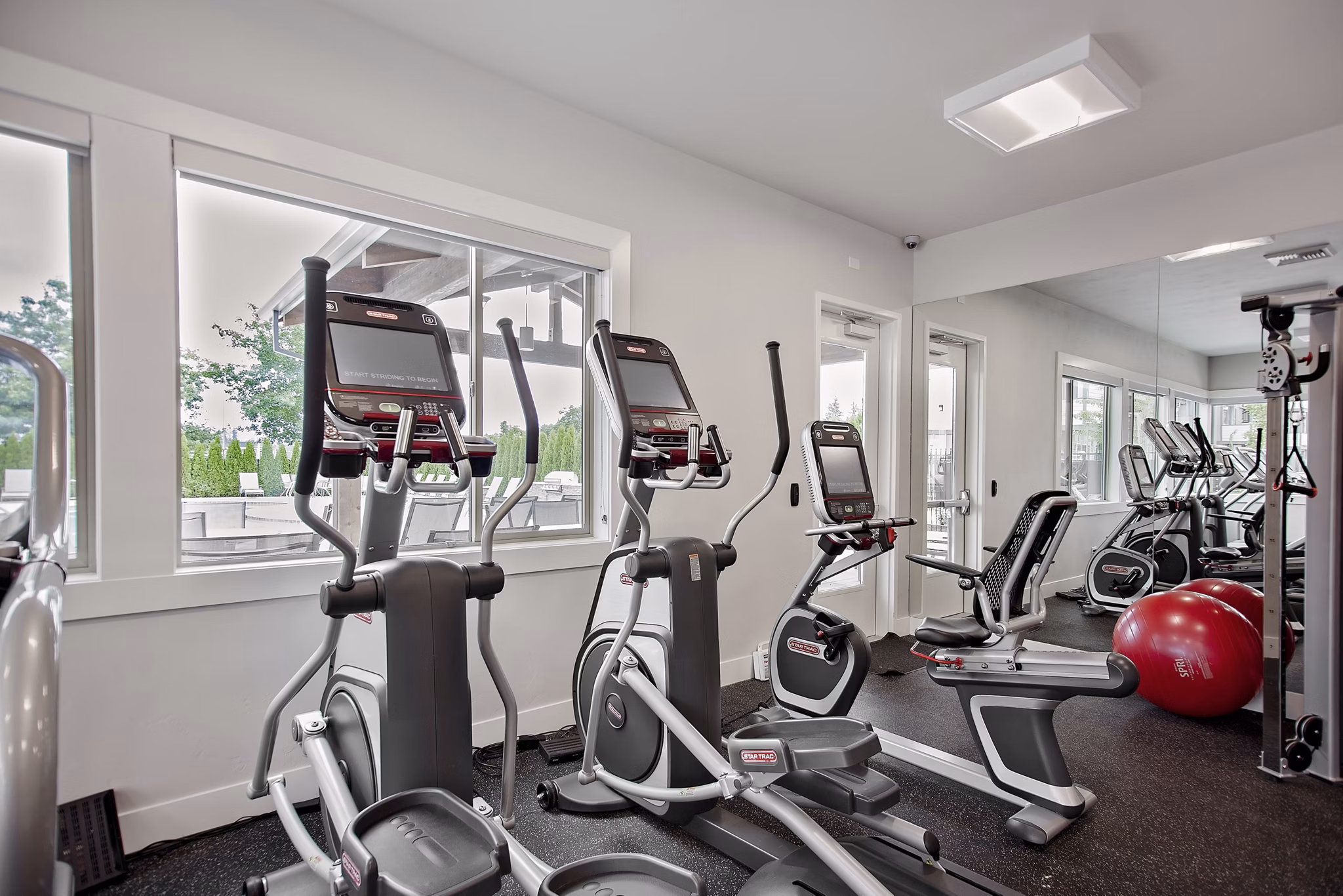 State-of-the-art fitness center at Trio Pointe luxury apartments, equipped with modern exercise machines and spacious workout areas