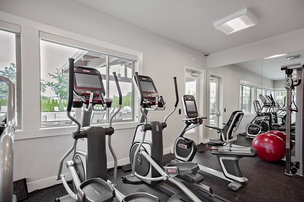 State-of-the-art fitness center at Trio Pointe luxury apartments, equipped with modern exercise machines and spacious workout areas