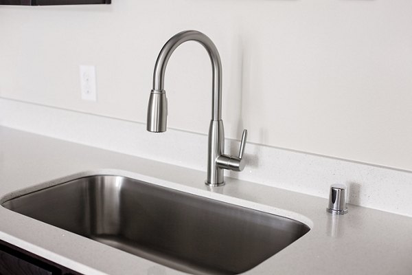 Sleek modern kitchen with stainless steel appliances at Trio Pointe luxury apartments