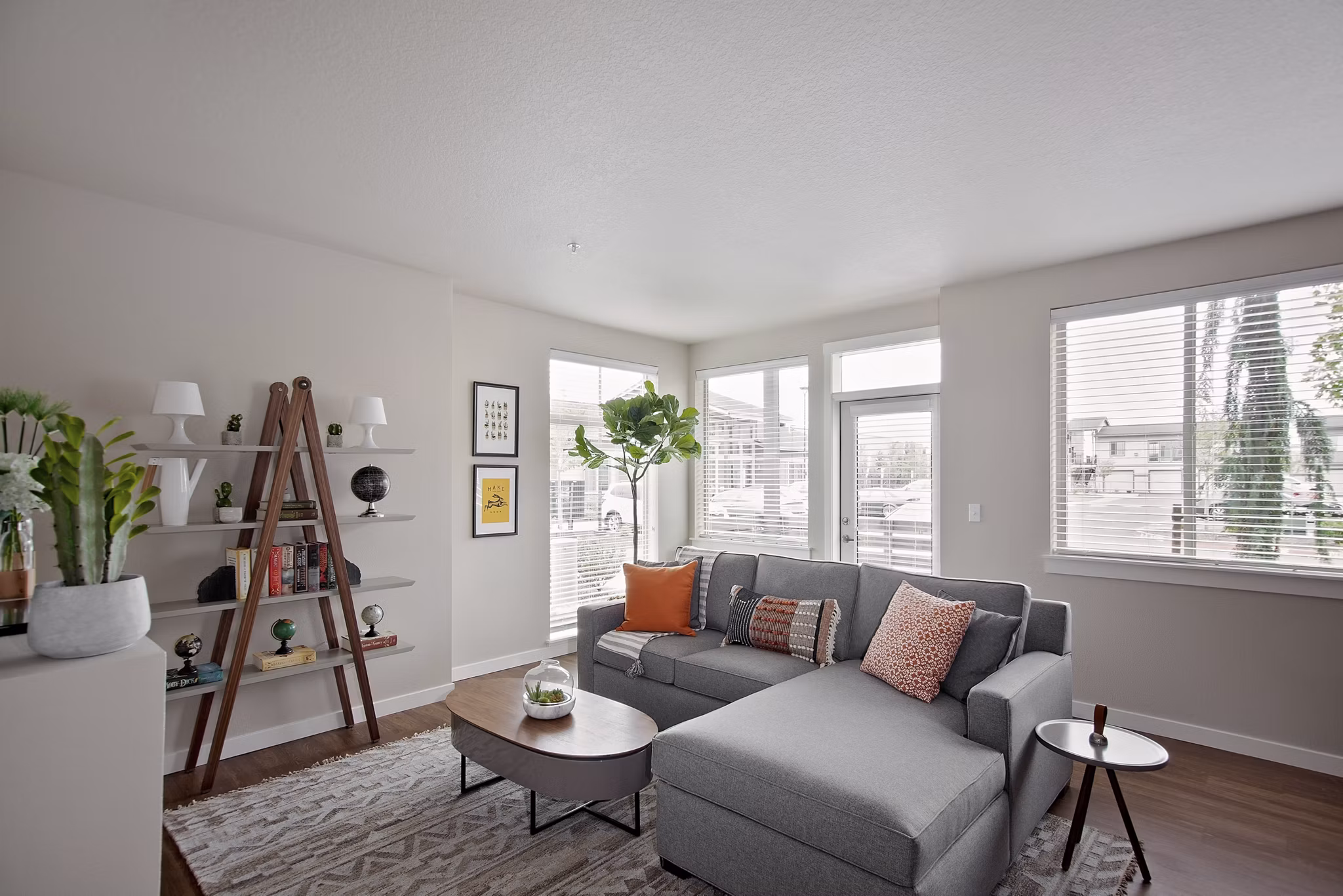 Chic living room with modern furniture and large windows in Trio Pointe apartments