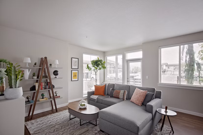 Chic living room with modern furniture and large windows in Trio Pointe apartments