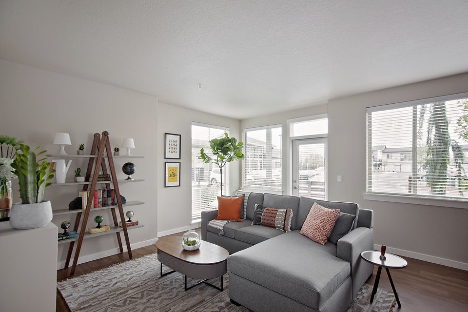 Chic living room with modern furniture and large windows in Trio Pointe apartments