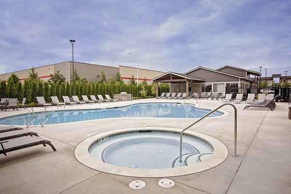 Relaxing outdoor hot tub at Trio Pointe luxury apartments with scenic views