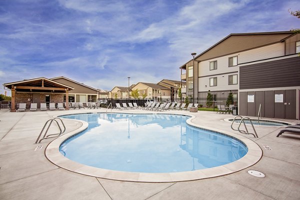 Serene poolside with lounge chairs at Trio Pointe luxury apartments