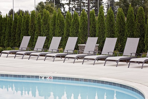 Resort-style pool with lounge chairs at Trio Pointe luxury apartments