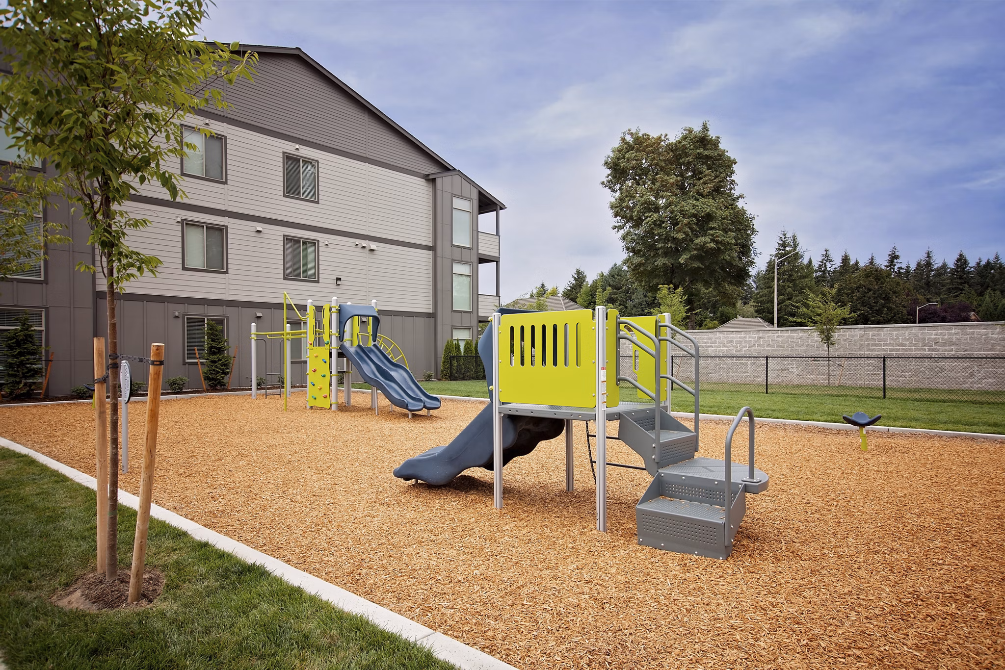 Modern playground with colorful equipment at Trio Pointe apartments, ideal for families seeking luxury living
