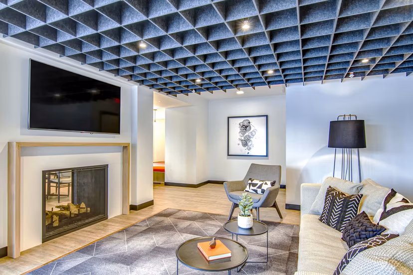 Clubhouse featuring modern furnishings and entertainment area at Irvine Exchange Apartments in a luxury Greystar community