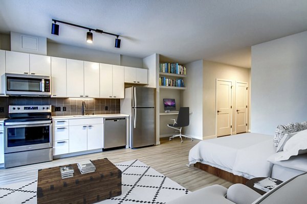 Modern kitchen with stainless steel appliances at Irvine Exchange Apartments