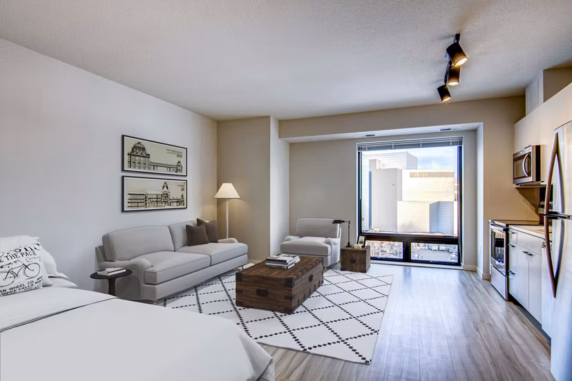 Modern kitchen featuring stainless steel appliances and granite countertops in Irvine Exchange Apartments