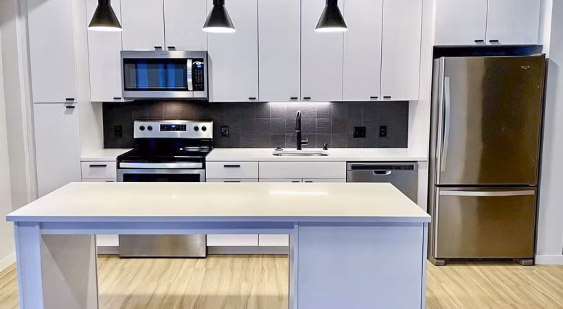 Modern kitchen with sleek countertops and stainless steel appliances at Irvine Exchange Apartments