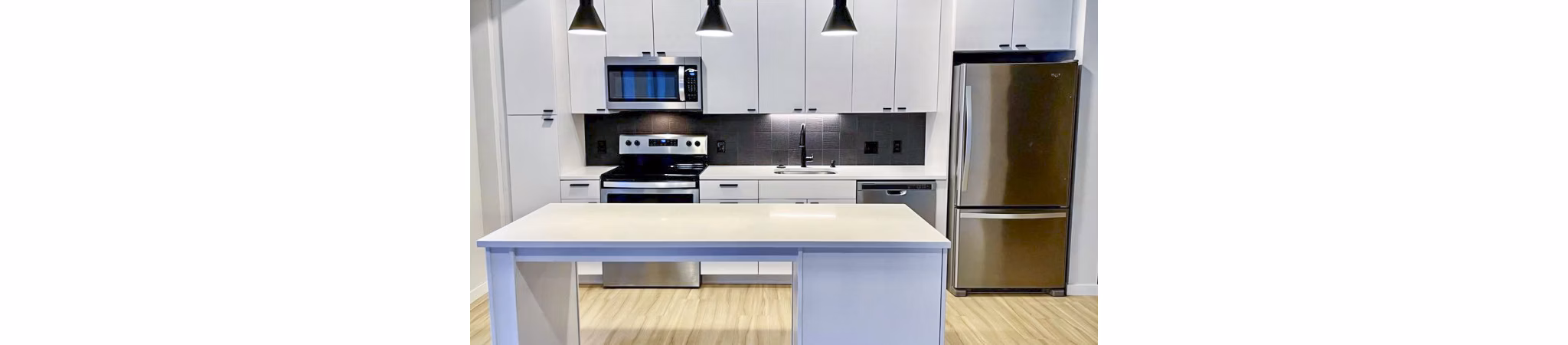 Modern kitchen with sleek countertops and stainless steel appliances at Irvine Exchange Apartments