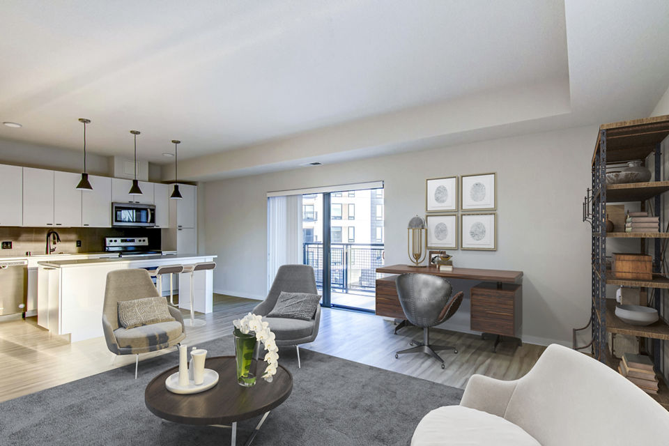 Modern living room with cozy seating and large windows at Irvine Exchange Apartments