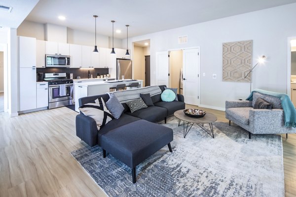Living room featuring modern decor and ample natural light at Irvine Exchange Apartments