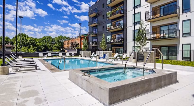 Resort-style pool with lounge seating at Irvine Exchange Apartments