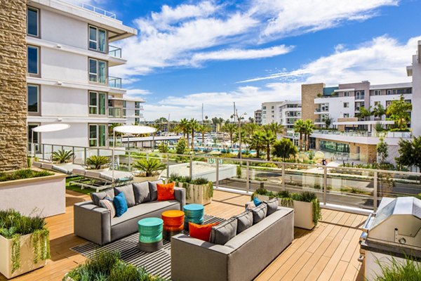 Elegant clubhouse patio with waterfront views at Neptune Marina Apartments