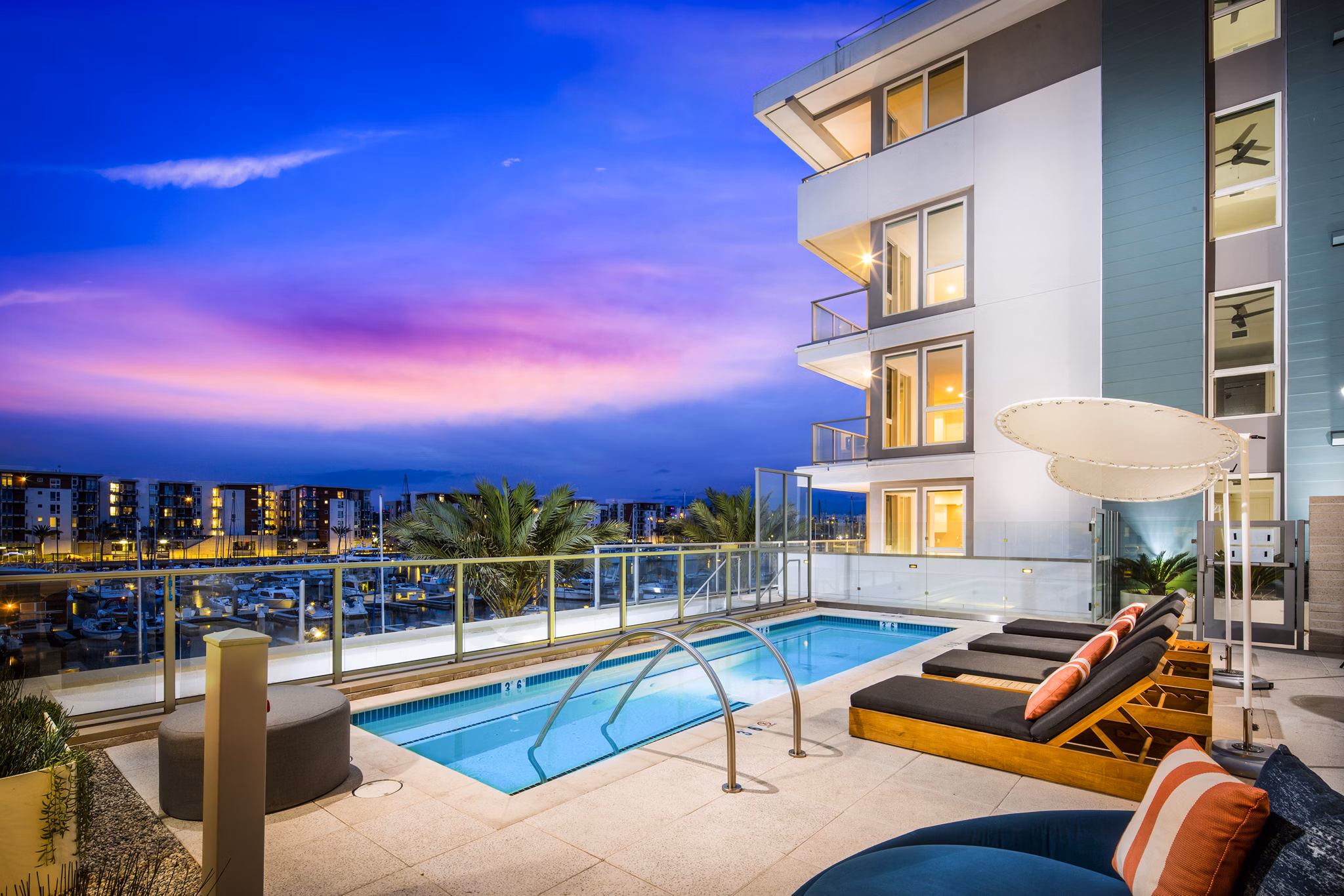 Resort-style pool with waterfront views at Neptune Marina Apartments