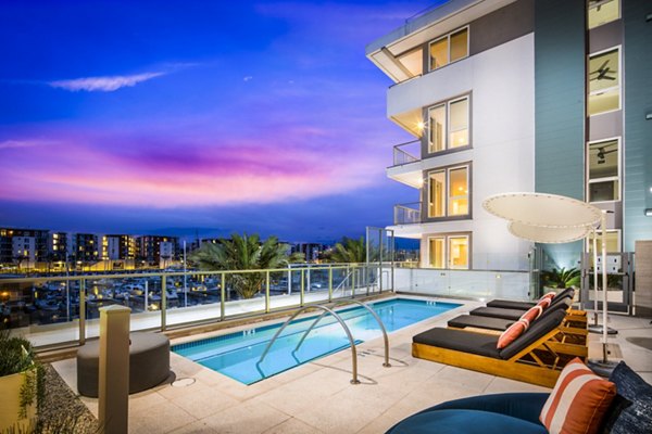 Resort-style pool with waterfront views at Neptune Marina Apartments