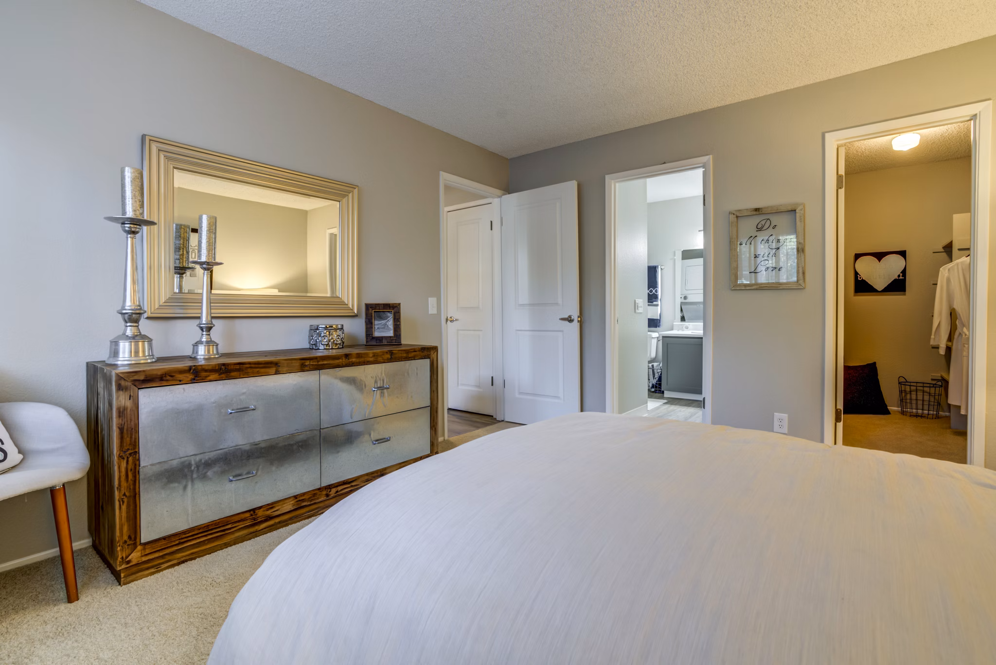 Cozy bedroom with contemporary decor and large windows at Avana San Jose Apartments