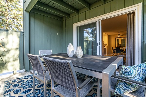 Outdoor patio featuring stylish seating and garden views at Avana San Jose Apartments
