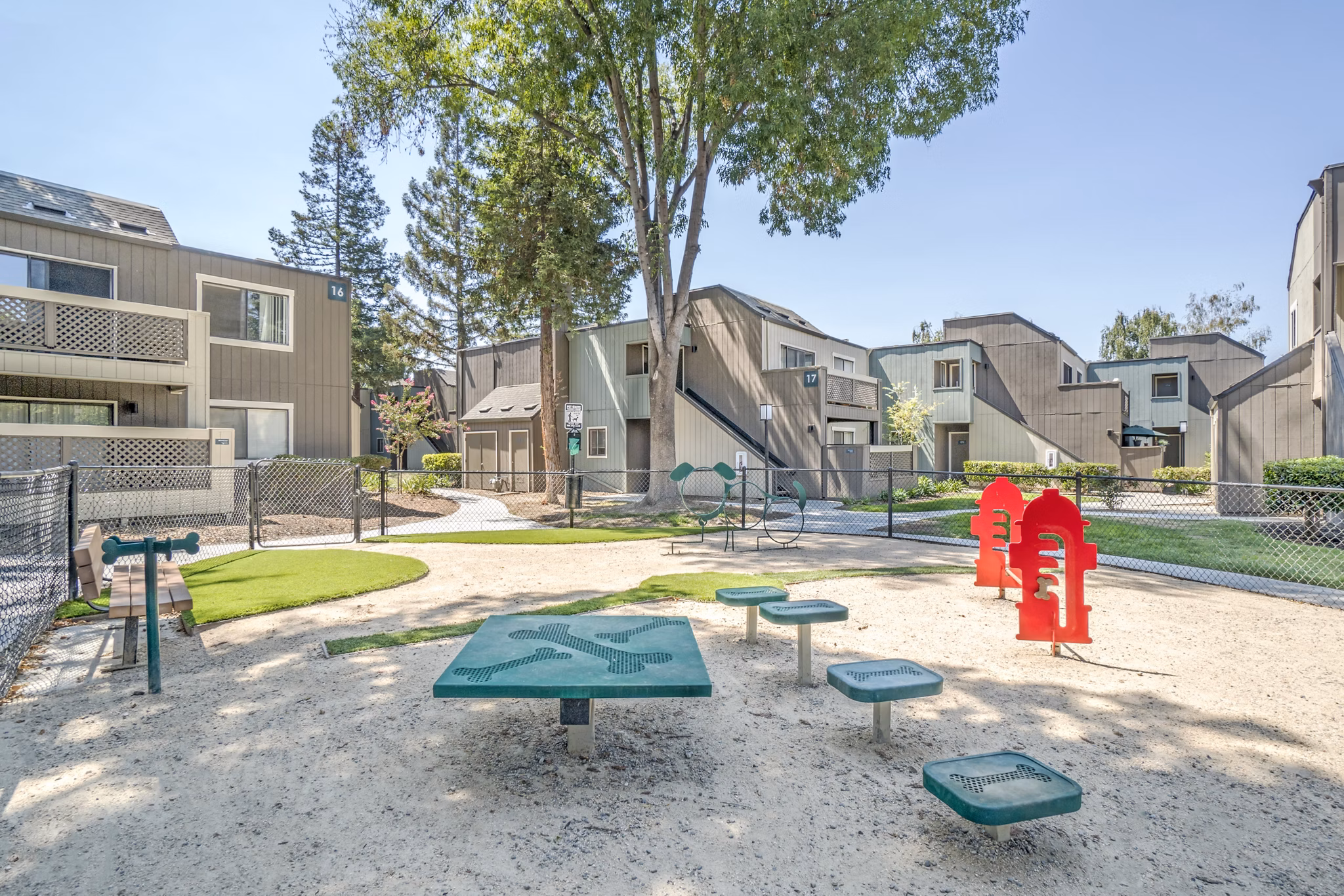 Fenced dog park with agility equipment at Avana San Jose Apartments
