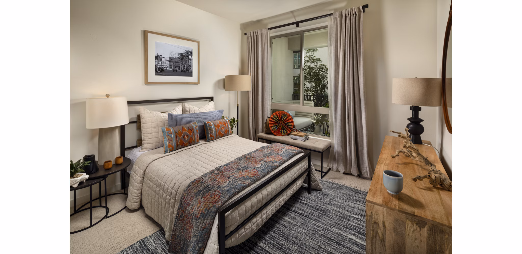 One Paseo Living Apartments: Stylish bedroom with modern decor and ample natural light