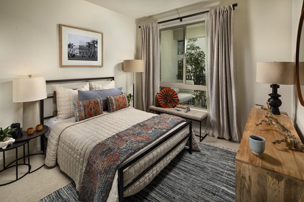 One Paseo Living Apartments: Stylish bedroom with modern decor and ample natural light