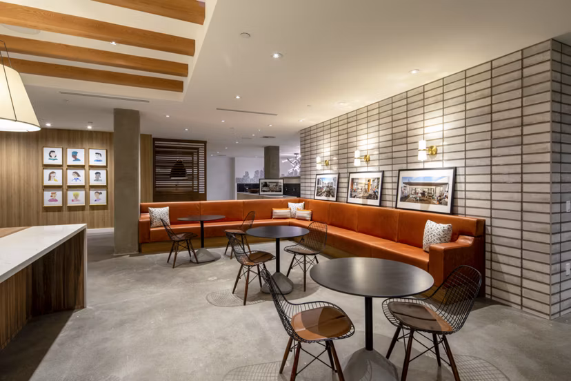 Modern clubhouse featuring cozy seating and a spacious design at One Paseo Living Apartments in vibrant San Diego