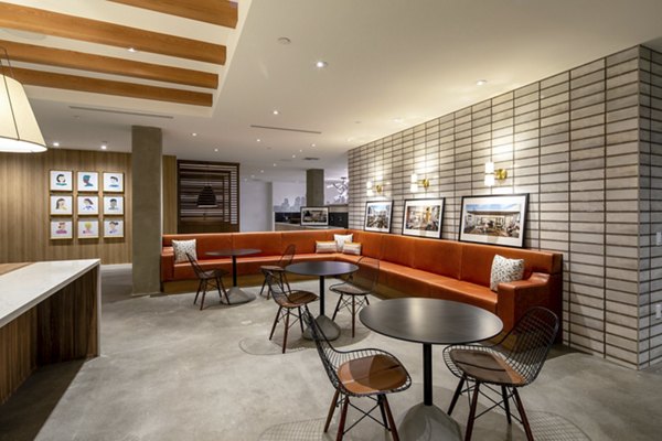 Modern clubhouse featuring cozy seating and a spacious design at One Paseo Living Apartments in vibrant San Diego