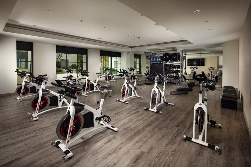 Tranquil yoga/spin studio at One Paseo Living Apartments featuring modern equipment and serene ambiance for luxury wellness