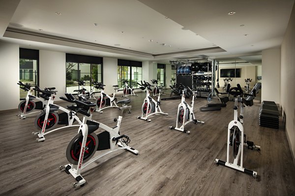 Tranquil yoga/spin studio at One Paseo Living Apartments featuring modern equipment and serene ambiance for luxury wellness