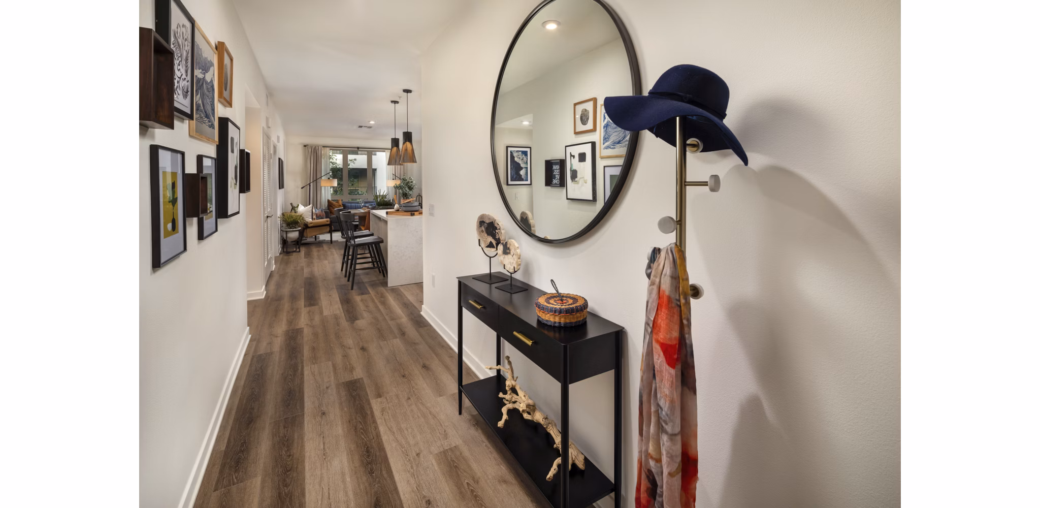 Hallway with modern lighting and artwork at One Paseo Living Apartments