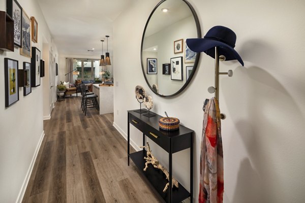 Hallway with modern lighting and artwork at One Paseo Living Apartments