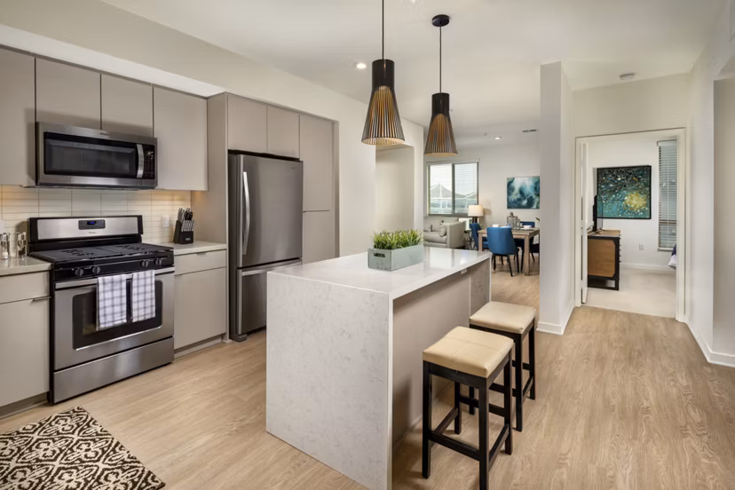 Modern kitchen with stainless-steel appliances at One Paseo Living Apartments
